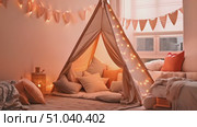 Peach bedroom with teepee adorned with twinkling lights, adding a cozy and inviting ambiance to the room. Стоковое AI-видео, аниматор Данила Большаков / Фотобанк Лори