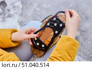 Rubber pad with ice grips for shoes are designed to provide better traction on icy surfaces. Стоковое фото, фотограф Владимир Григорьев / Фотобанк Лори