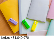 Beautiful notebooks or notebooks for studying or writing in beautiful pastel shades, for school, universities or working on a wooden surface that creates a warm and cozy background. Редакционное фото, фотограф Анастасия Мерчик / Фотобанк Лори