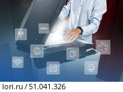 Operating a multifunction printer in an office during the afternoon with digital icons. Стоковое фото, фотограф Сергей Толмачёв / Фотобанк Лори
