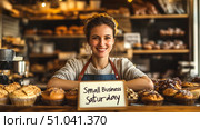 Smiling bakery owner celebrating small business saturday with fresh artisan pastries. Стоковое AI-изображение, AI-художник Сергей Бирюков / Фотобанк Лори