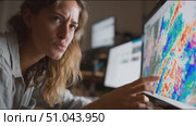 Expert analyzes weather patterns using advanced technology in a modern workspace during evening hours. Стоковое AI-видео, аниматор Сергей Толмачёв / Фотобанк Лори