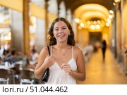 In evening, young smiling girl walks along city street Placa Real. Стоковое фото, фотограф Яков Филимонов / Фотобанк Лори