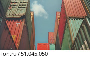 Multiple cargo containers are positioned adjacently to each other in a uniform manner, creating a sense of order and storage in an industrial setting. Стоковое AI-видео, аниматор Данила Большаков / Фотобанк Лори