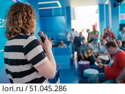 Speaker addressing an audience during a professional event in modern setting. Стоковое фото, фотограф Антон Гвоздиков / Фотобанк Лори
