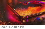 A detailed view of a cell phone placed on a table, showing the devices screen and design. Стоковое AI-видео, аниматор Данила Большаков / Фотобанк Лори