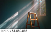 Bright rays illuminate a simple room with a ladder and window during the morning hours. Стоковое AI-видео, аниматор Сергей Толмачёв / Фотобанк Лори