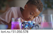 Young inventor experiments with robotics and science in modern lab setting. Стоковое AI-видео, аниматор Сергей Толмачёв / Фотобанк Лори