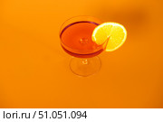 Glass of champagne with orange slice on orange background, top view. Стоковое фото, фотограф Кашапова Эльвира / Фотобанк Лори