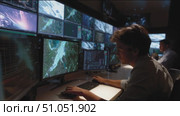 Monitoring data analysis in a modern control room with multiple screens displaying satellite imagery. Стоковое AI-видео, аниматор Сергей Толмачёв / Фотобанк Лори