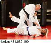 Karate with male athletes practicing, training and sparring in fight class. Стоковое фото, фотограф Яков Филимонов / Фотобанк Лори