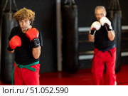 Martial arts fighter preparing for sparring in boxing gloves. Стоковое фото, фотограф Яков Филимонов / Фотобанк Лори