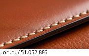 Macro closeup of brown leather texture with neat stitching. Concept of handmade craftsmanship, quality materials and luxury goods with fine expensive details. Стоковое AI-изображение, AI-художник Павел Муравьев / Фотобанк Лори