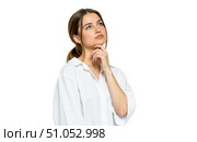 Young brunette woman in white shirt looking up with thoughtful expression, hand on chin, isolated on white background, thinking deeply, making decision. Стоковое AI-изображение, AI-художник Павел Муравьев / Фотобанк Лори