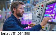 Operator uses control panel in a modern manufacturing facility during shift hours. Стоковое AI-видео, аниматор Сергей Толмачёв / Фотобанк Лори