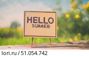 A hello summer sign is displayed on a wooden table in this video, showcasing a simple and rustic seasonal decoration. Стоковое AI-видео, аниматор Данила Большаков / Фотобанк Лори