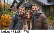 Two men and a woman standing together in front of a house, possibly discussing or posing for a photo. Стоковое AI-видео, аниматор Данила Большаков / Фотобанк Лори