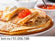 Stack of russian pancakes blini with red caviar, fresh sour cream. Стоковое фото, фотограф Ирина Буракова / Фотобанк Лори