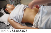 Young woman receiving stomach massage in spa salon. Closeup. Стоковое видео, видеограф Владислав Тригуб / Фотобанк Лори