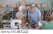 Group of elderly people sewing on machine working with mannequin and making patterns in class. Стоковое видео, видеограф Яков Филимонов / Фотобанк Лори