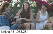 Young and two adult women applying mosquito repellent in cottage garden. Стоковое видео, видеограф Яков Филимонов / Фотобанк Лори