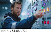 Operator monitors control panel and adjusts settings at industrial facility during daytime. Стоковое AI-видео, аниматор Сергей Толмачёв / Фотобанк Лори