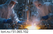 Scientists conduct research on chemical reactions in a controlled lab environment with advanced equipment and safety gear. Стоковое AI-видео, аниматор Сергей Толмачёв / Фотобанк Лори