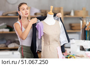 Young tailoress trying ready jacket on mannequin. Стоковое фото, фотограф Яков Филимонов / Фотобанк Лори