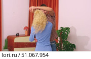 Caucasian Couple dancing together in a brightly decorated indoor room. Стоковое видео, видеограф Raquel Corcoles Mendez / Фотобанк Лори
