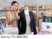 Young tailoress trying ready jacket on mannequin. Стоковое фото, фотограф Яков Филимонов / Фотобанк Лори