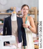 Young tailoress trying ready jacket on mannequin. Стоковое фото, фотограф Яков Филимонов / Фотобанк Лори