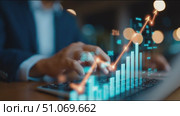 Business professional analyzes data trends while using a laptop in an office during evening hours. Стоковое AI-видео, аниматор Сергей Толмачёв / Фотобанк Лори