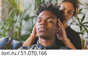 Relaxing head massage given by a skilled stylist in a contemporary salon setting. Стоковое AI-видео, аниматор Данила Большаков / Фотобанк Лори