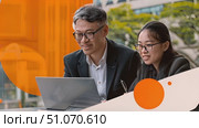 Two business professionals, a man and a woman, are working on a laptop outside an office building. They are smiling and seem to be collaborating. Стоковое AI-видео, аниматор Данила Большаков / Фотобанк Лори
