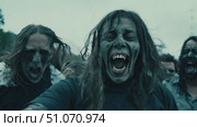 A large group of zombies run through a city street during the daytime. Стоковое AI-видео, аниматор Данила Большаков / Фотобанк Лори