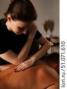 Soothing Medical Massage Session in a Tranquil Indoor Space for Relaxation and Recovery. Стоковое фото, фотограф Aleksandr Golubev / Фотобанк Лори