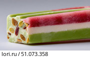 Delicious nougat bar showing green, white and red layers. Стоковое AI-изображение, AI-художник Юрий Поздников / Фотобанк Лори
