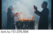 Participants engage in a solemn ritual, surrounded by candles and a mystical atmosphere. Стоковое AI-видео, аниматор Данила Большаков / Фотобанк Лори