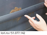 Close-up of female hand touching car rust spot. Стоковое фото, фотограф Ветерцовская Галина Валериевна / Фотобанк Лори