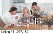 Old woman deciding and signing inheritance papers in family circle. Old woman signing papers. Стоковое видео, видеограф Яков Филимонов / Фотобанк Лори