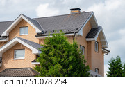 Elegant House with Modern Roof Tiles and Chimney View. Стоковое фото, фотограф Дмитрий Брусков / Фотобанк Лори