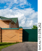 Modern Brick House with Green Metal Gate. Стоковое фото, фотограф Дмитрий Брусков / Фотобанк Лори