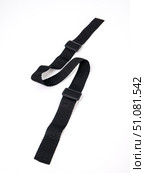 Black strap lies in a zigzag pattern on a white background. Стоковое фото, фотограф Катерина Белякина / Фотобанк Лори