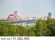 Moscow, Russia. - May 26, 2025: View of Moscow's high-rise buildings and stadiums from the Krylatsky Hills. Редакционное фото, фотограф Наталия Кирсанова / Фотобанк Лори