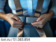 Getting ready to embark on a journey by fastening seatbelt safety harness. Стоковое AI-изображение, AI-художник Katsiaryna Repich / Фотобанк Лори