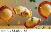 Golden empanadas with a crispy crust, some filled and some whole, floating against a soft background with scattered herbs. Стоковое AI-видео, аниматор Nart / Фотобанк Лори