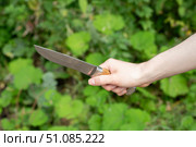 A man with a knife in his hands. Aggression and death threats. Стоковое фото, фотограф Александр Поташев / Фотобанк Лори