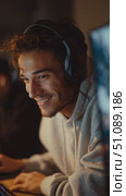 Young man enjoys gaming session with friends in cozy environment during evening hours. Стоковое AI-видео, аниматор Сергей Толмачёв / Фотобанк Лори