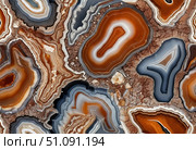 Intricate designs emerge from agate mineral stones, showcasing a blend of earthy tones. Each piece tells a story of natures artistry, perfect for enhancing any space with elegance Generative AI. Стоковое AI-изображение, AI-художник Юлия Петровская / Фотобанк Лори