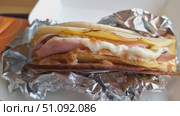 Pete with omelet, bacon and cheese, in foil, takeaway food. Стоковое видео, видеограф Zakharova Natasha / Фотобанк Лори